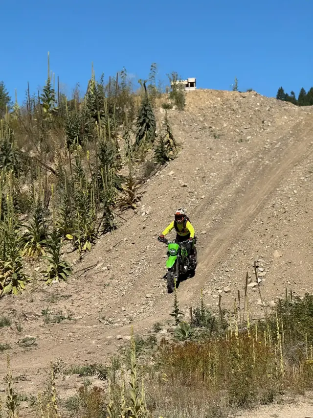 A WeRoam rider climbing a dirt hill at Training Camp